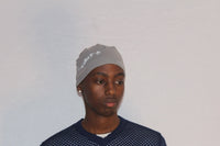Grey skull cap by Alamòd Archives, stylish and comfortable headwear with a casual, modern design.