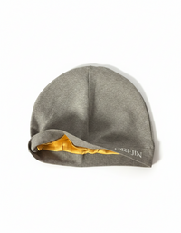 White Orijin Grey Skull Cap by Alamòd Archives, featuring a detailed skull graphic design on soft fabric.